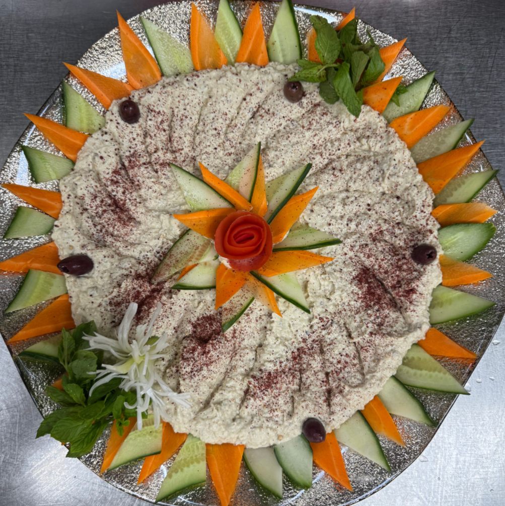 Baba ghanoush party tray with carrot and cucumber garnish